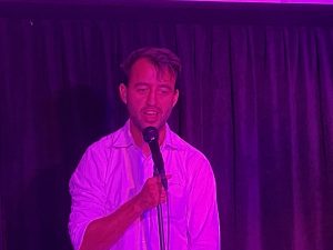 Aidan Jones on stage performing at the Adelaide Fringe gala at The Producers Hotel